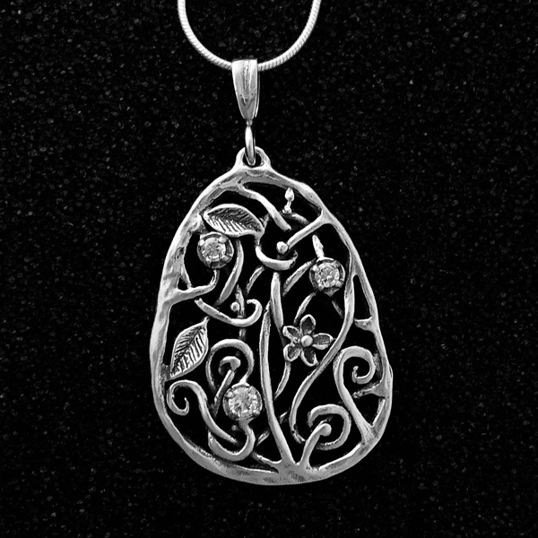 vertical ovoid pendant with floral and vines design; 3 prong set czs